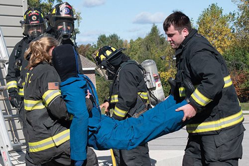 firemen carrying dummy
