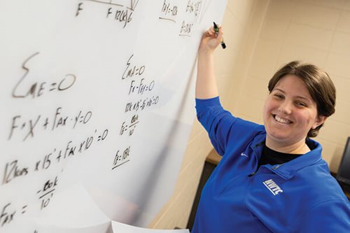 woman writing on whiteboard
